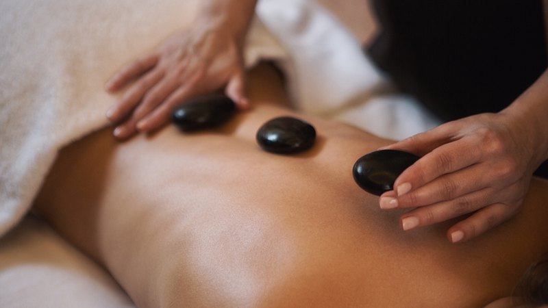 Hot stone massage is a soothing therapy that involves the heated stones placed on the body. 